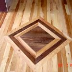 A hardwood floor with a distinct diamond-shaped inlay design