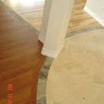 A transition point between a wood floor and a tiled area