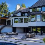 large glass windows with black frames on house exterior