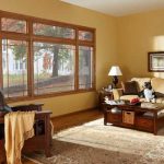 living room with large window overlooking a tree