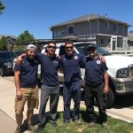 Four people taking a photo