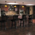 A modern kitchen with a large island and bar stools