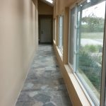 A hallway or corridor with large windows