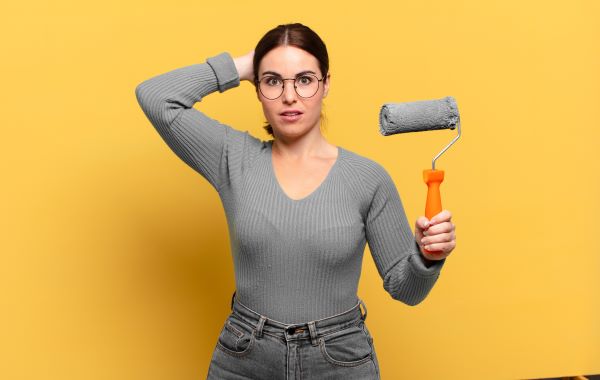 woman holding a wall painting brush