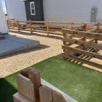 residential properties separated by low wood fence