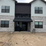 main entrance door of a house covered by awning
