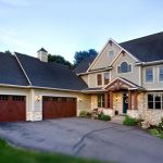 modern suburban home with a prominent attached garage and a well-landscaped front yard