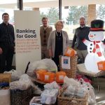FirstBank staff posing for a group photo with donation packs