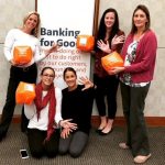 bank employees holding orange boxes and showing their palms