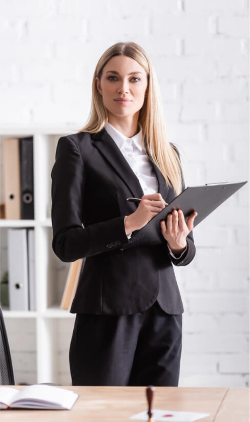img - blonde-notary-clipboard-pen-looking-camera-office