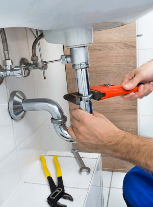 Closeup of a plumber fixing a broken sink