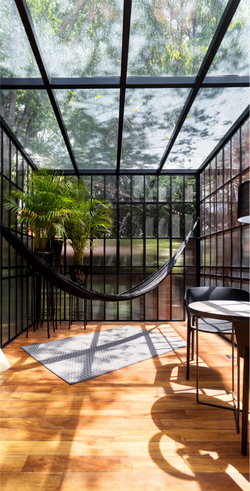 modern-sunroom-with-a-hammock-and-some-plants