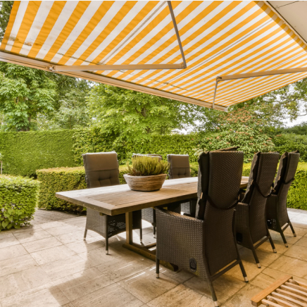 img - outdoor-dining-area-table-chairs-large-yellow-striped-awning-patio