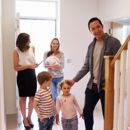 realtor showing family around property for sale