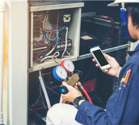 HVAC technician checking air conditioner system