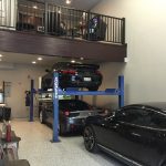 A garage condo unit with three parked cars