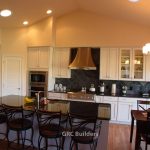 modern kitchen design with black chairs surrounding bar