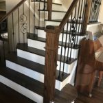 wooden staircase with dark treads and white risers
