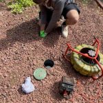 plumber inspecting a drain line with plumbing snake