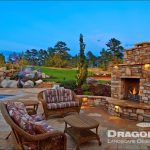 stone poolscape design with waterfall feature and firepit area