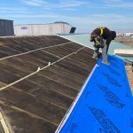 worker hammering the roof