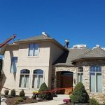 workers repairing a house roof