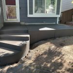 A newly constructed concrete staircase and an adjoining concrete porch